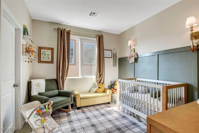 bedroom featuring a nursery area