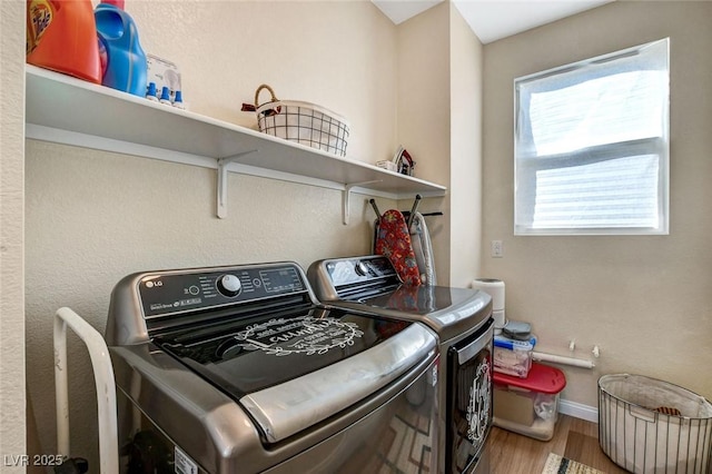 laundry room featuring hardwood / wood-style flooring and washing machine and dryer