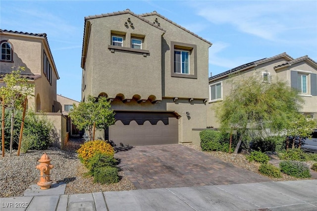 mediterranean / spanish-style home with a garage