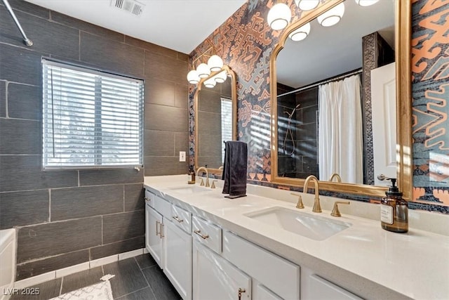 bathroom with tile walls, vanity, and tile patterned floors