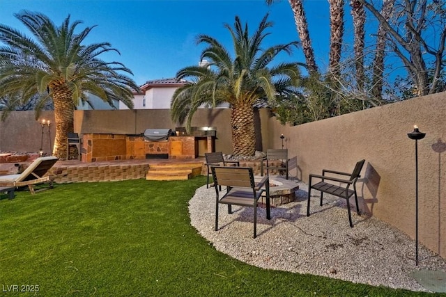 view of yard with a patio and an outdoor kitchen