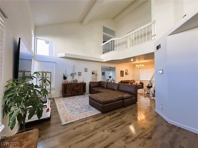 living room featuring high vaulted ceiling, dark wood-type flooring, beamed ceiling, and an inviting chandelier