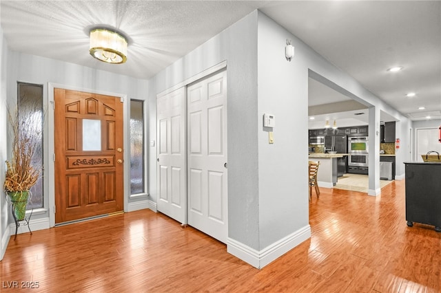 entrance foyer featuring sink and light wood-type flooring