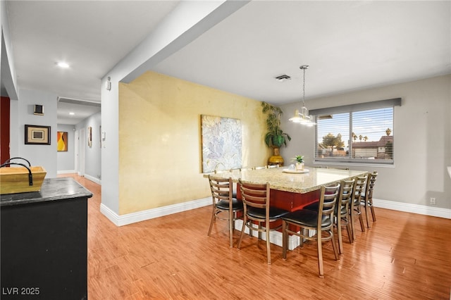 dining space with light hardwood / wood-style floors