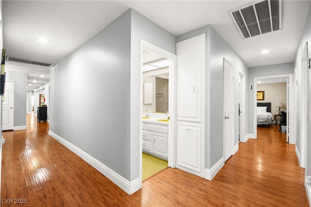 hall featuring sink and light hardwood / wood-style flooring