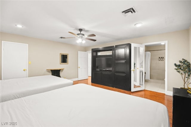 bedroom featuring ceiling fan, connected bathroom, and hardwood / wood-style floors