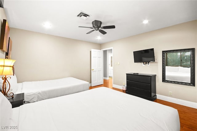 bedroom with hardwood / wood-style floors and ceiling fan