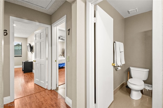 bathroom with wood-type flooring and toilet