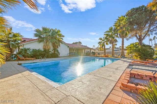 view of swimming pool with a patio