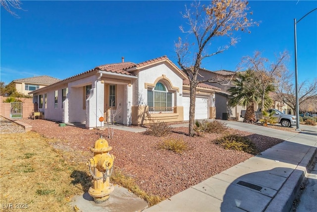 mediterranean / spanish-style home with a garage