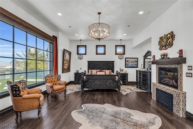 bedroom with hardwood / wood-style floors and a chandelier