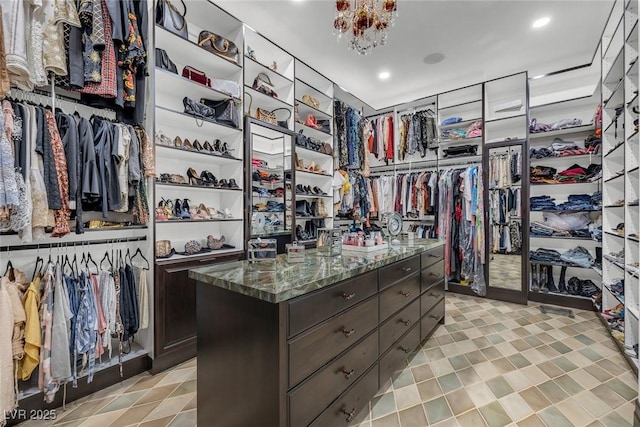 spacious closet featuring an inviting chandelier