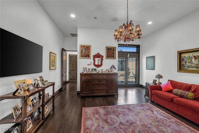 living area with french doors, a notable chandelier, dark wood finished floors, recessed lighting, and baseboards