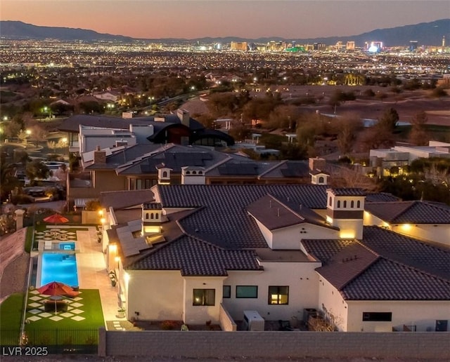 aerial view at dusk with a view of city and a mountain view