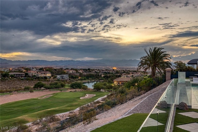 view of community featuring view of golf course and a water and mountain view