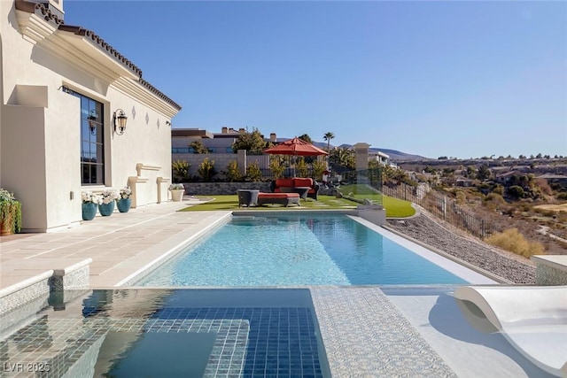 view of swimming pool with a fenced in pool, a patio, and fence