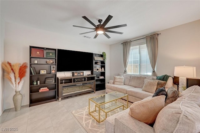 living room featuring ceiling fan and tile patterned flooring