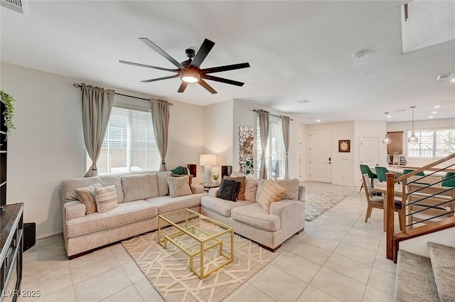 living room featuring light tile patterned flooring, plenty of natural light, and ceiling fan