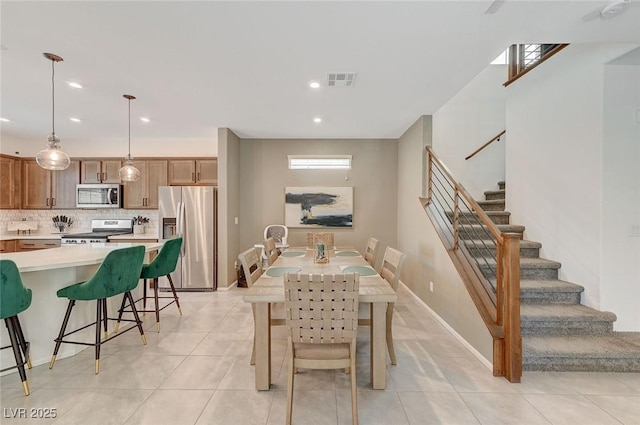 dining space featuring light tile patterned flooring