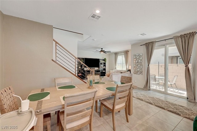 dining space featuring ceiling fan and light tile patterned floors