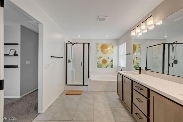 bathroom with independent shower and bath, vanity, and tile patterned flooring