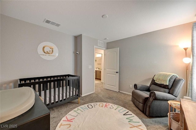 carpeted bedroom featuring a crib