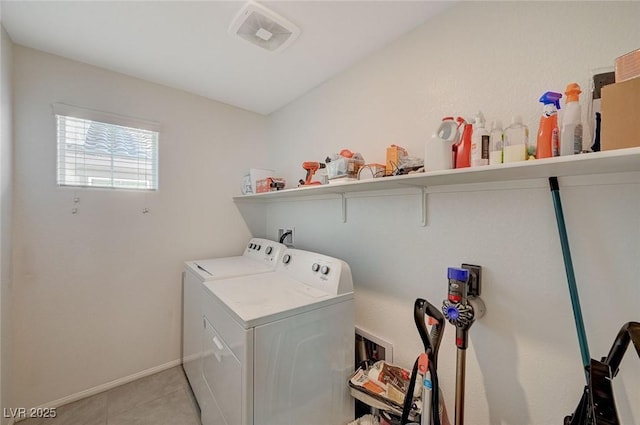 washroom featuring light tile patterned floors and washing machine and clothes dryer