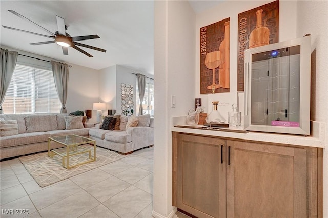 living room featuring ceiling fan and light tile patterned floors