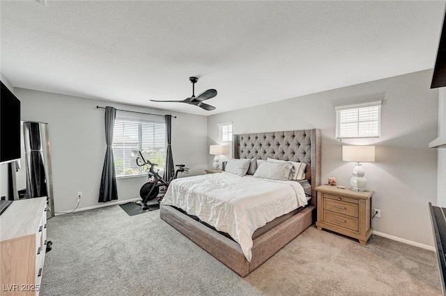 carpeted bedroom featuring ceiling fan and multiple windows