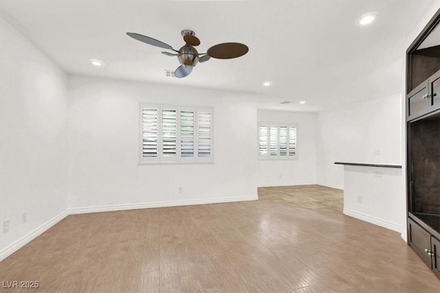 unfurnished living room with ceiling fan and light hardwood / wood-style floors