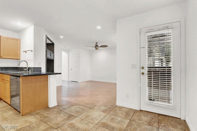 kitchen with dishwasher, light brown cabinets, sink, kitchen peninsula, and ceiling fan