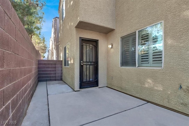 entrance to property featuring a patio area