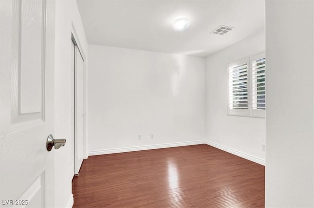 interior space with a closet and dark hardwood / wood-style floors