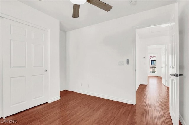 spare room with hardwood / wood-style flooring and ceiling fan