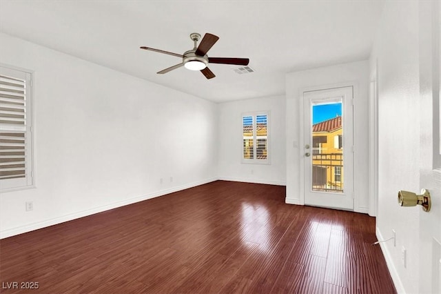 empty room featuring ceiling fan and dark wood-type flooring