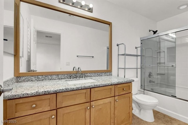 full bathroom featuring tile patterned floors, shower / bath combination with glass door, vanity, and toilet