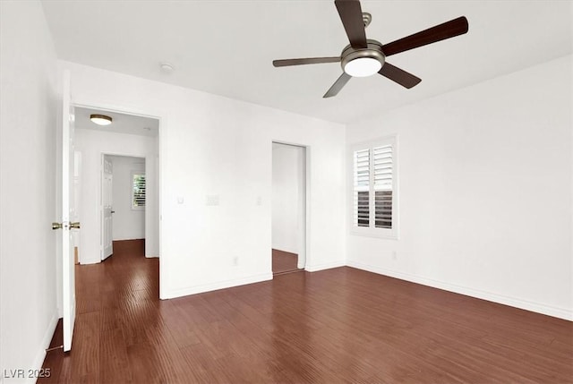 empty room featuring ceiling fan and dark hardwood / wood-style flooring