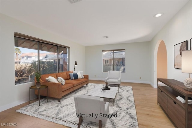 living room with a wealth of natural light and light wood-type flooring