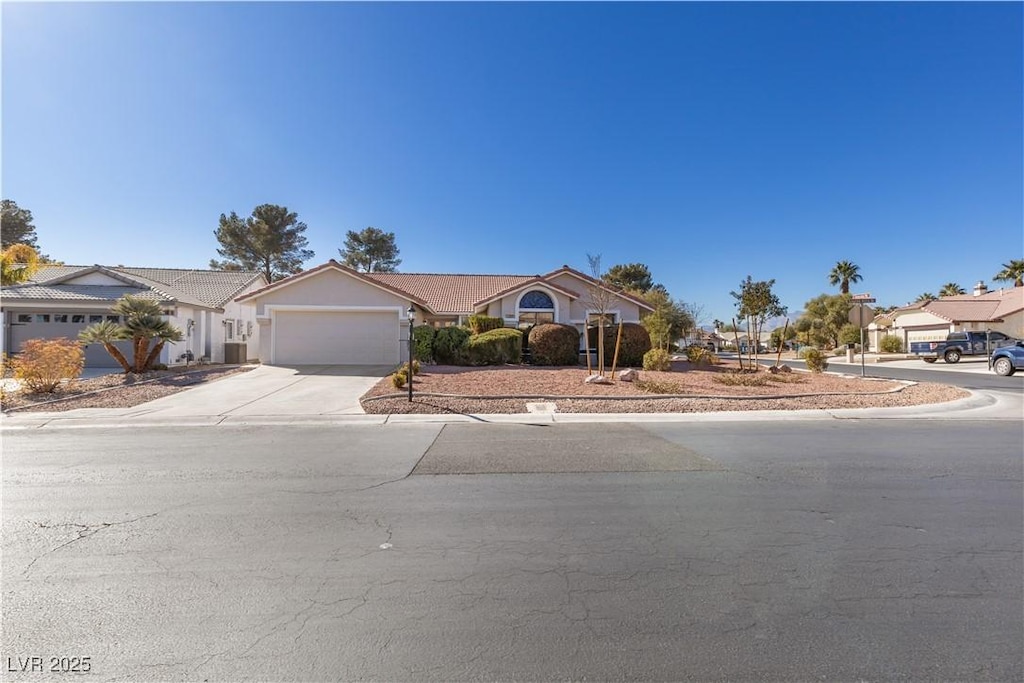 view of front of home with concrete driveway and a garage