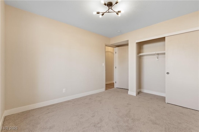 unfurnished bedroom with light carpet and a closet