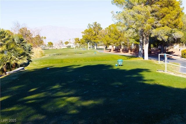 view of home's community featuring a mountain view and a lawn