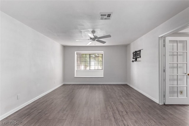 empty room with dark wood-type flooring and ceiling fan