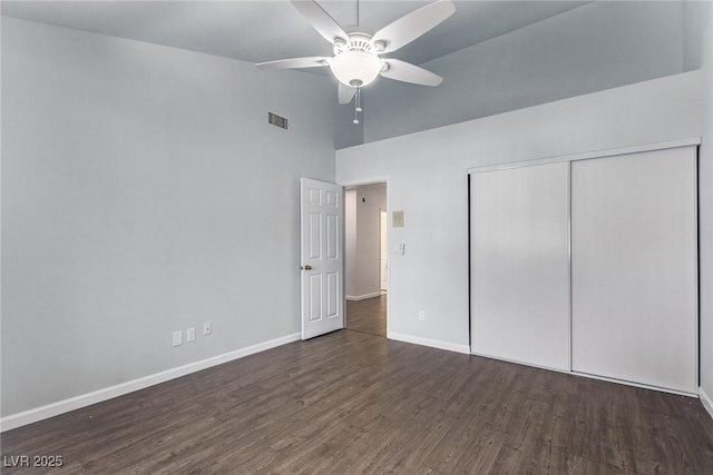 unfurnished bedroom featuring a closet, ceiling fan, and dark hardwood / wood-style flooring