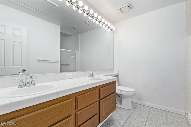 bathroom with toilet, vanity, and walk in shower