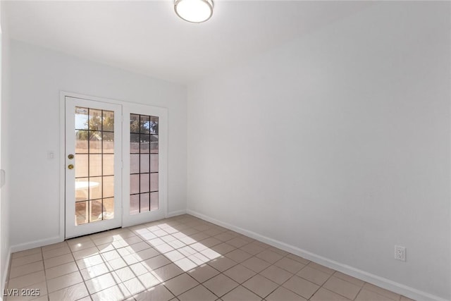 spare room featuring light tile patterned flooring