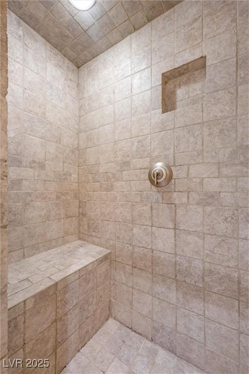 bathroom with tiled shower