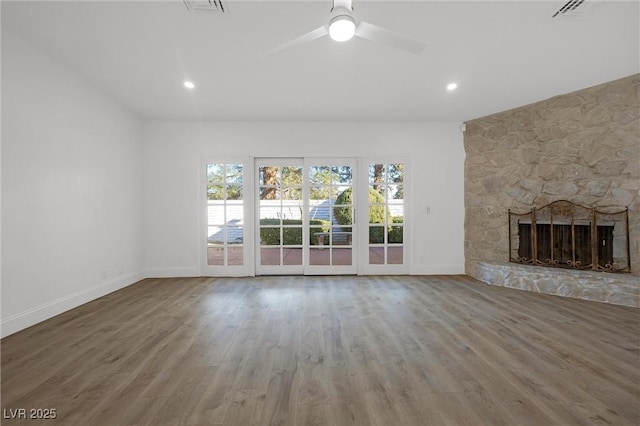 unfurnished living room featuring a fireplace, hardwood / wood-style floors, and ceiling fan