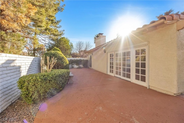 view of side of property with a patio area