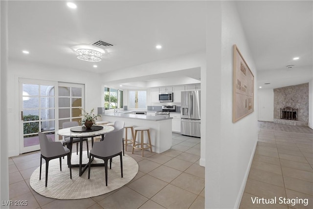 tiled dining space featuring a fireplace