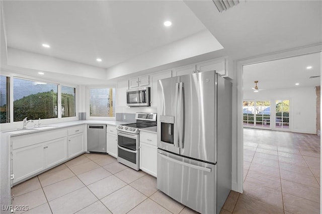 kitchen featuring white cabinetry, light tile patterned floors, and stainless steel appliances